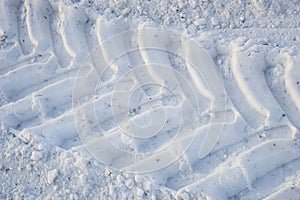 The imprint of wheels big tractor in snow