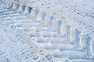 The imprint of wheels big tractor in snow