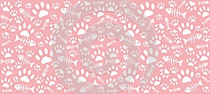 Imprints of cat`s paws and skeletons of white fish on a pink background.