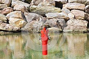 An improbable hydrant at the seaside. Plenty of water concept image