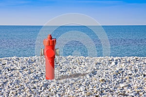 An improbable hydrant at the seaside. Plenty of water concept image
