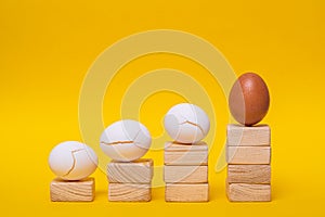 An impromptu career ladder in the form of chicken eggs moving towards success photo