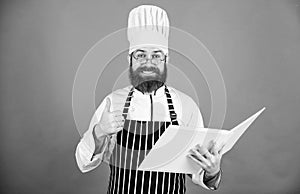 Improve cooking skill. Book recipes. According to recipe. Man bearded chef cooking food. Culinary arts concept. Amateur