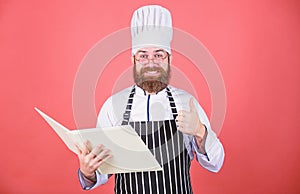 Improve cooking skill. Book recipes. According to recipe. Man bearded chef cooking food. Culinary arts concept. Amateur