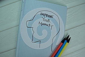 Improve Your Memory write on a book isolated on office desk