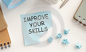 Improve your skills word on office table with computer, coffee, notepad, smartphone and digital tablet