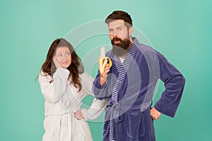 Improving potency naturally. Sexy woman look at bearded man eating banana. Sexual potency. Couple in love blue