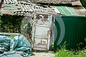 Improvised gate doors and house of refugee or homeless people in the ghetto of the city