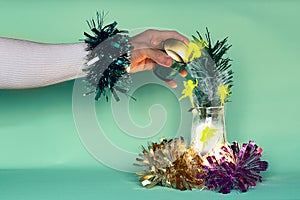 The improvised hand of the magician on new year`s eve pours fairy light from one glass to another. Fairy creatures frolic in the