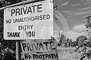 Improvised and polite Private sign seen attached to a rusted gate at an entrance to a paddock.