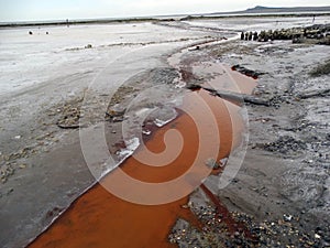 Impurity of salts coloured the water of a stream in orange