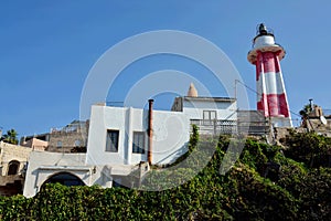 Inactive red and white striped lighthouse in Old Yaffo port Jaffa, Yafo, Tel Aviv, Israel,Middle East photo