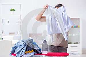 The inattentive husband burning clothing while ironing