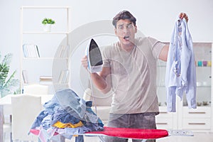 The inattentive husband burning clothing while ironing