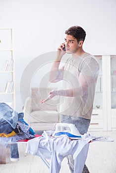 The inattentive husband burning clothing while ironing