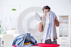 The inattentive husband burning clothing while ironing