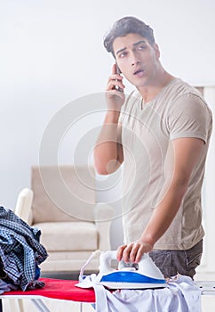 Inattentive husband burning clothing while ironing