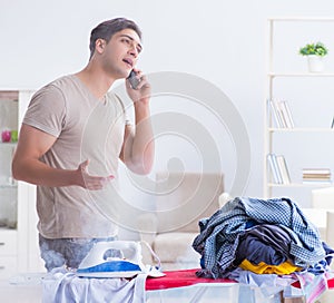 The inattentive husband burning clothing while ironing