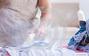 Inattentive husband burning clothing while ironing