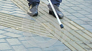 Inattentive pedestrian crossing road in front of blind man with cane, disrespect