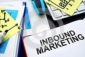 Inbound marketing. Book, reports and pen on table.