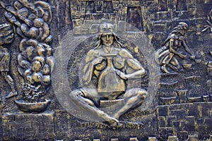 Inca bas-reliefs on the wall in Aguas Calientes, Peru