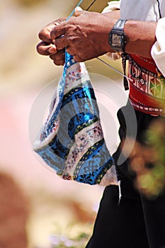 Inca men knitting a hat in Taquile, Island Puno, Peru photo