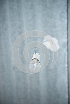 Incandescent lamp. obsolete light bulb on the ceiling in an empty apartment