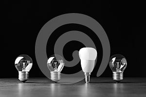 Incandescent and LED lamp bulbs on grey table