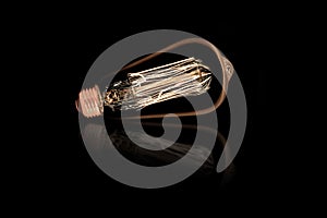 Incandescent light bulb on black