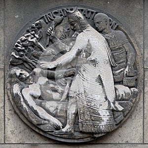 Incantation. Stone relief at the building of the Faculte de Medicine Paris.