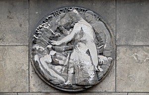 Incantation. Stone relief at the building of the Faculte de Medicine Paris.