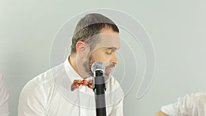 Incendiary singer singing into a microphone on the