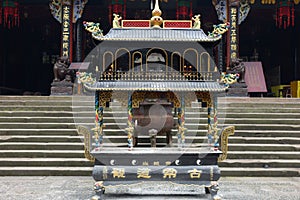A incense burner in front of temple