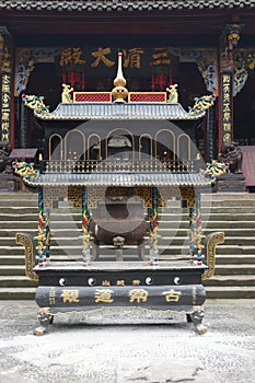 A incense burner in front of temple