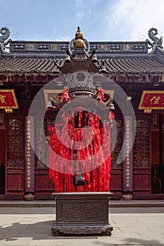 Incense burner with red praying ribbons at Hanshan Temple, in Suzhou, China