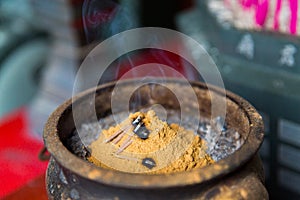 Incense burning Embossed in an incense big stone pot in a buddhistic asian temple in Taiwan