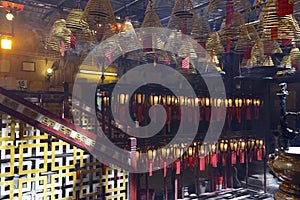 Incense burning with lanterns in dimly lit, traditional Temple in Hong Kong