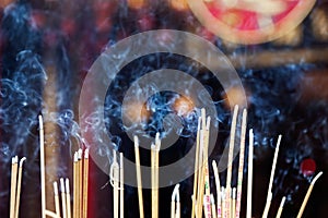 Incense left burning by worshipers at Wong Tai Sin Temple