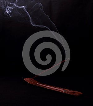 Incense and mystery smoke on black background