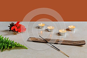 incense with orange flower and candles on display