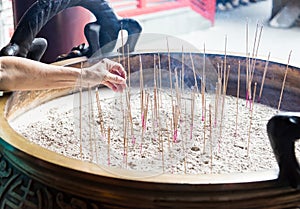 Incense sicks from the old woman hand photo