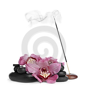 Incense stick smoldering in holder near orchid flowers and spa stones on white background