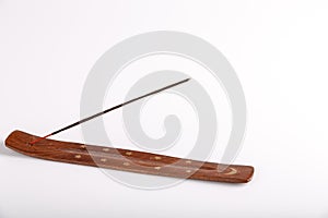 Incense stick on a wooden support