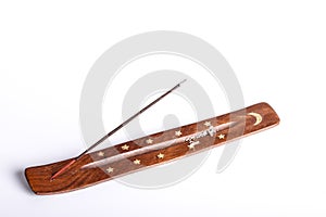 Incense stick on a wooden support