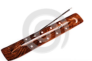 Incense stick on a wooden support on a white background