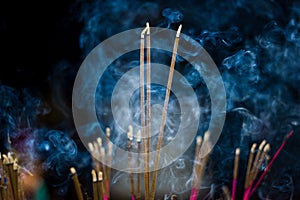 Incense sticks with blue smoke