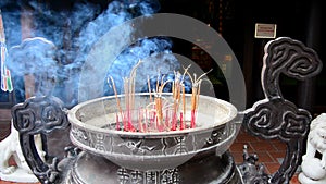 Incense Sticks Burning in Giant Pot in Front of Buddhist Temple