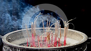 Incense Sticks Burning in Giant Pot in Front of Buddhist Temple