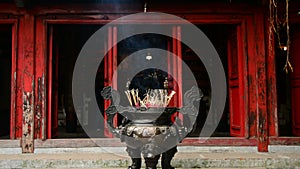 Incense Sticks Burning in Giant Pot in Front of Buddhist Temple